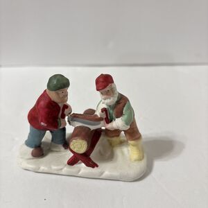Porcelain Christmas Village Figurine. Sawing Wood